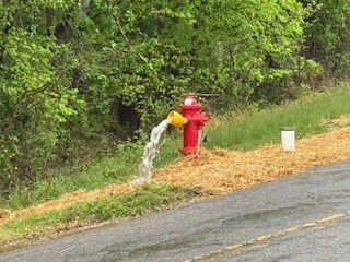 Water flowing from a hydrant for the first time that was installed as part of the project