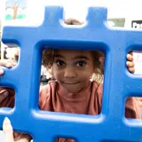 Child holding block in classroom