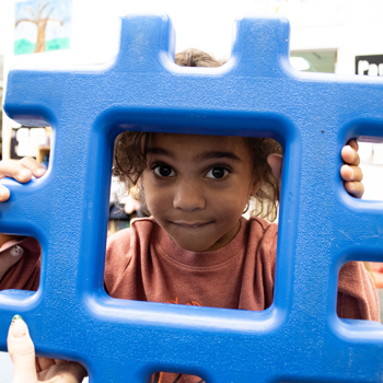 Child holding block in classroom