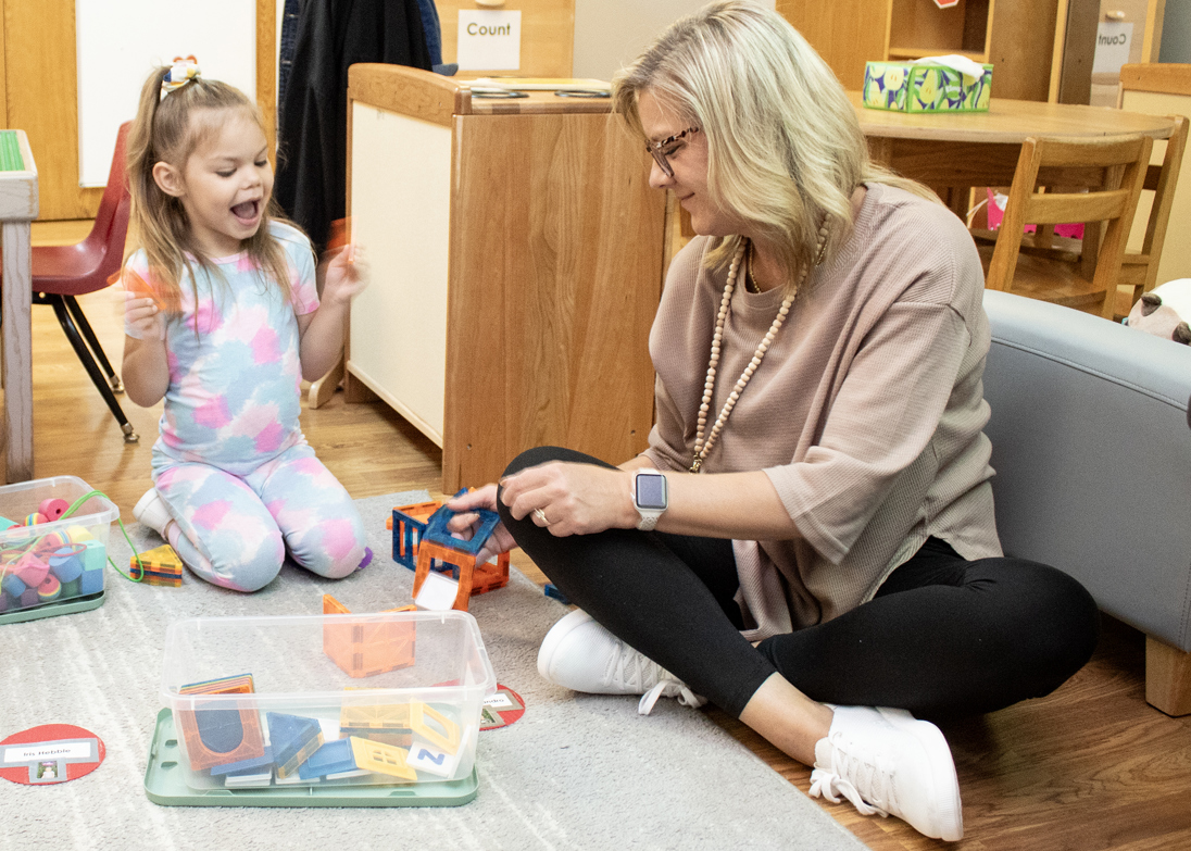 teacher playing with Head Start student