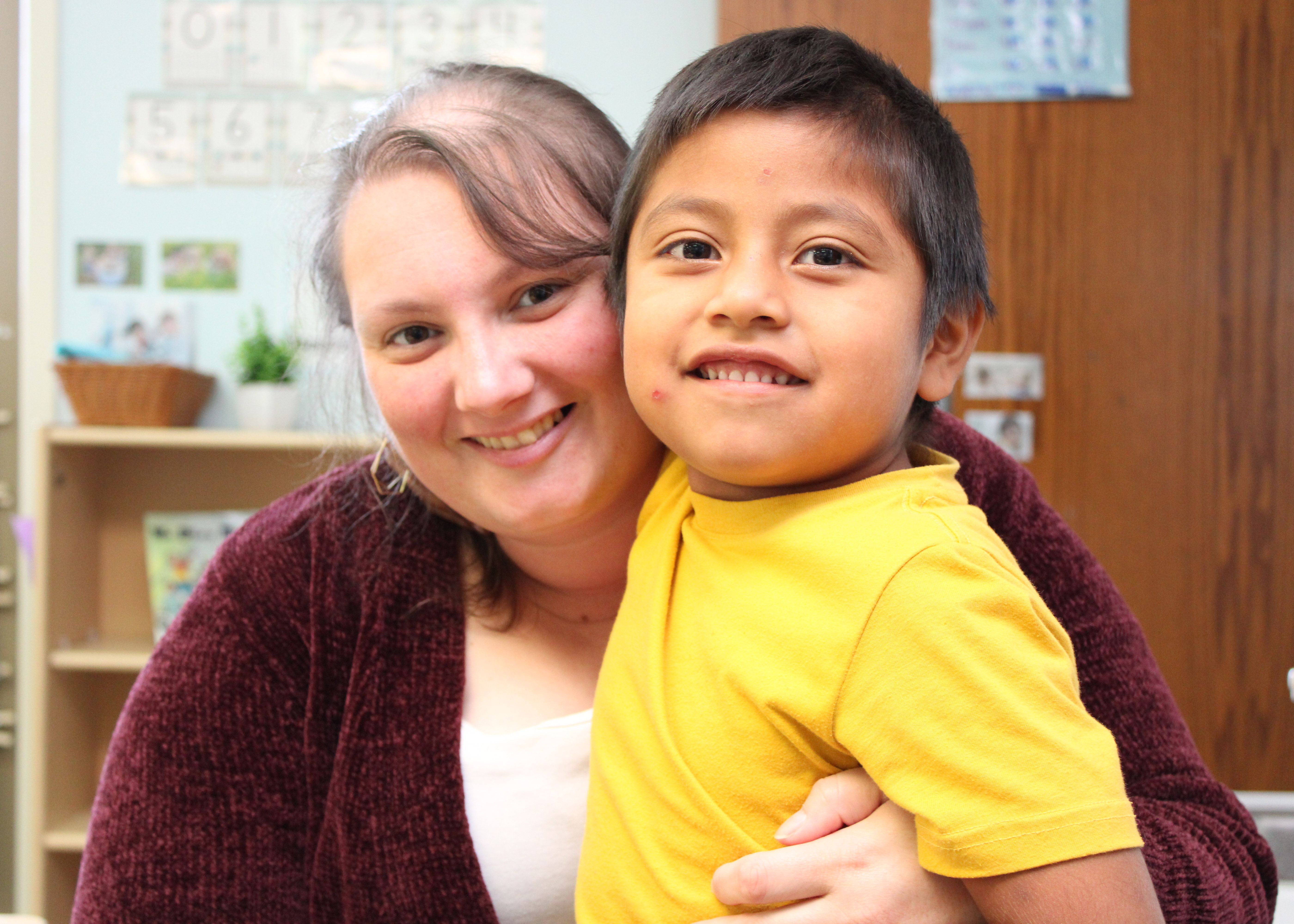 Teacher and student smiling for the camera