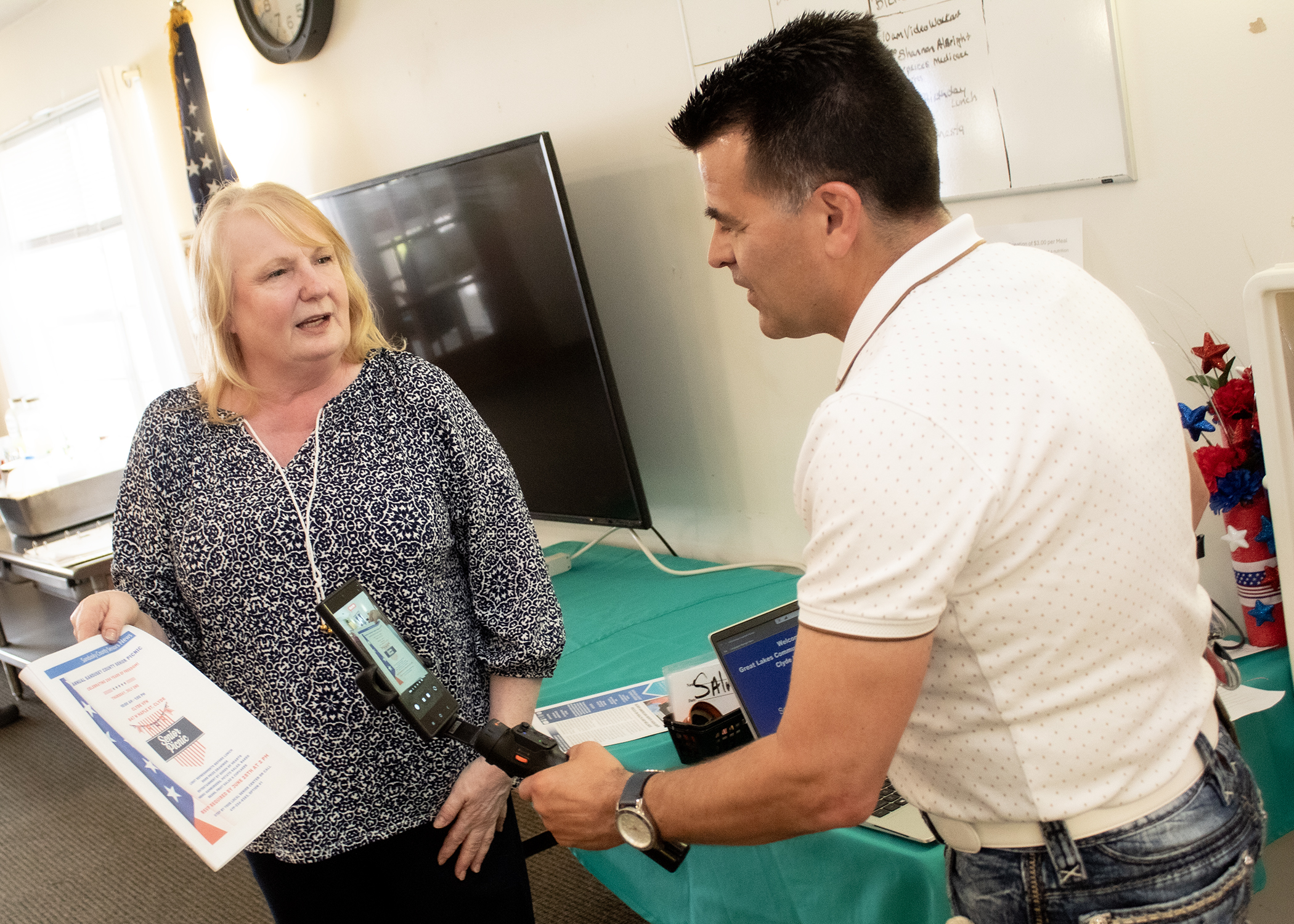 Sonny Workman filming the senior newsletter and interviewing Senior Site Supervisor Donna Key