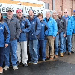 Meals on Wheels staff near vehicle