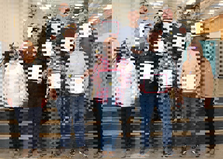 Ten students hold certificates for welding graduation