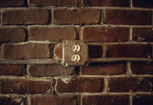 Electric outlet on a brick wall